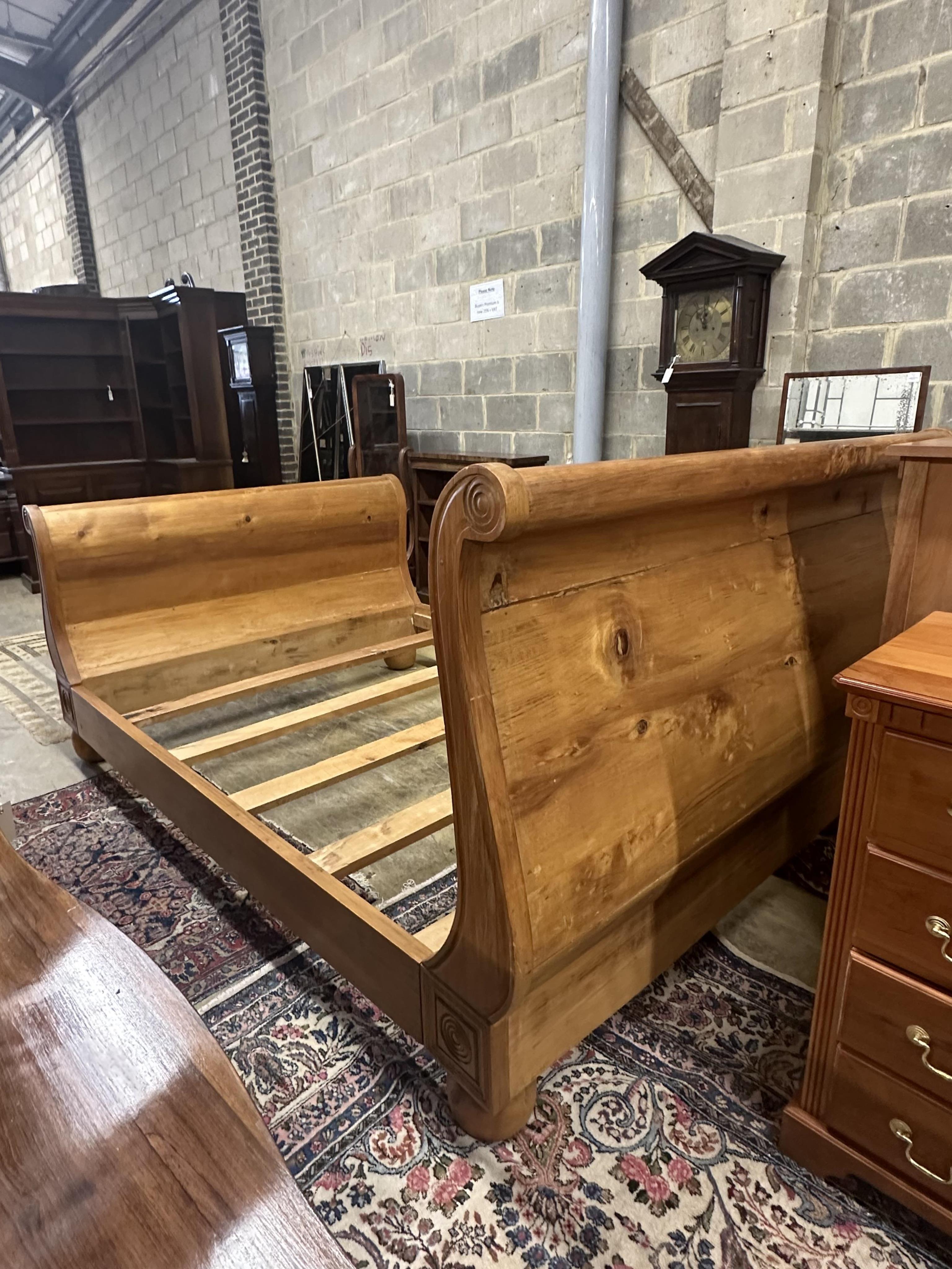 A Continental pine sleigh bed, width 164cm, length 250cm, height 120cm. Condition - poor-fair